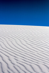 Fototapeta na wymiar Deep Ripples In Undisturbed Sand Dune With Dark Blue Sky Above