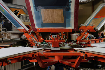 print screening apparatus. serigraph printing production. silk screen textile printery
