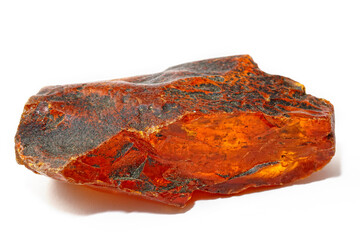 Red amber on a white background. Solar stone with inclusions. Natural fossilized resin. Copal. semi-precious mineral. Material for jewelry and ornaments. Crystal. Resin 