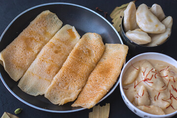 one of the famous Bengali food during winter season, "pitha-puli" . is made of rice powder,milk and sugar syrup.  