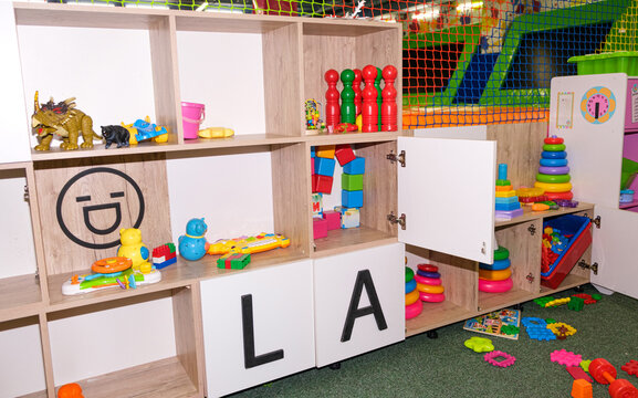 Cabinets With Toys In The Children's Entertainment Center, Toys For Children On The Rack