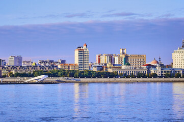 Fototapeta na wymiar Russian-Chinese border along the Amur River. View from the embankment of the city of Blagoveshchensk, Russia to the city of Heihe, China. A mixture of architectural styles.