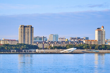 Fototapeta premium Russian-Chinese border along the Amur River. View from the embankment of the city of Blagoveshchensk, Russia to the city of Heihe, China. A mixture of architectural styles.