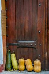 Pumpkins and zucchini on the wooden door