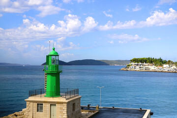 Green lighthouse in the port of Split, Croatia and bright blue sky. - Powered by Adobe