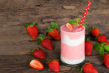 Strawberry yogurt fruit juice smoothie pink colorful fruit juice milkshake blend beverage healthy high protein the taste yummy In glass drink episode morning on wood background.