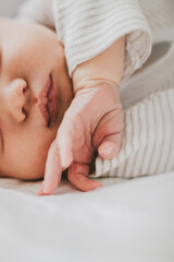 Newborn baby child sleeping. Soft focus close-up macro of newborn baby lips and hand.