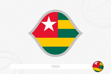 Togo flag for basketball competition on gray basketball background.