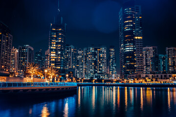 Fantastic nighttime skyline with illuminated skyscrapers. Dubai, UAE