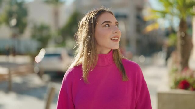 Young blonde woman smiling confident looking city map at street