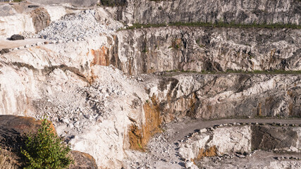 Dolomite quarry Photo from above. Industrial terraces in a quarry. Aerial view of open pit mining. Excavations of the Dolomite mine. Mining industry.