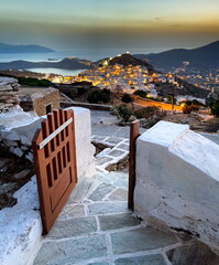 Panoramic view of the old city at sunset, beautiful gate, evening time night, cycladic islands, ios...
