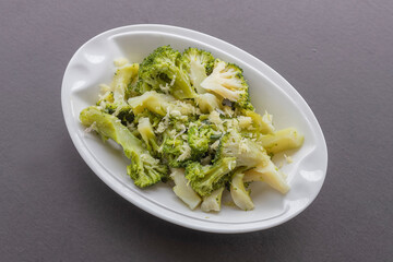 Roasted broccoli with garlic parmesan on black background