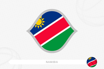 Namibia flag for basketball competition on gray basketball background.