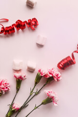 bouquet of flowers and festive decor on a pink background