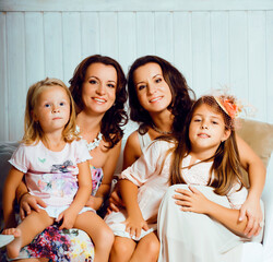 Fototapeta premium young pretty modern family at home happy smiling, lifestyle people concept, mother with cute little daughter, sister twins together
