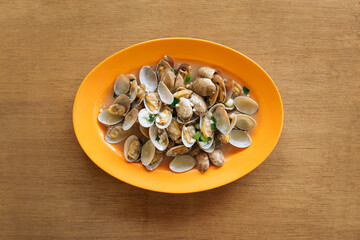 Chinese clams with black bean sauce and garlic on wooden table background