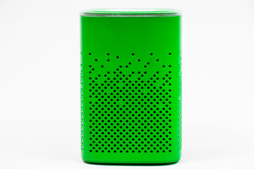 portable green speaker on white background.the concept of listening to music. wireless audio playback device. 