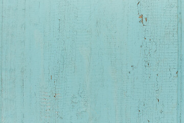Old shabby wooden planks with cracked color paint, background. light blue
