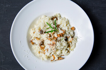 Tasty creamy risotto with mushrooms and almonds, top view. Traditional italian cuisine. 