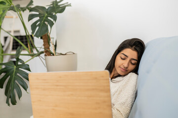 indian woman sleeping at home with computer