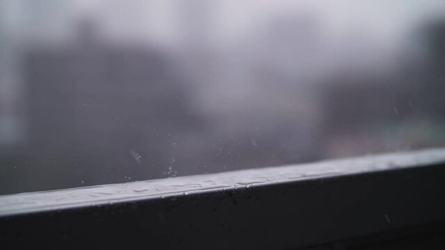 raindrops dripping onto the metal fence