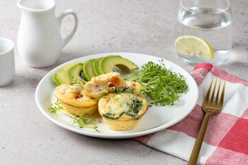 Healthy breakfast with omelet muffins with vegetables, microgreens, infused water. Metabolism boosters.