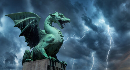  View of the Dragon bridge (Zmajski most), symbol of Ljubljana, capital of Slovenia, Europe. Sculpture of a dragon against a dark stormy sky. - Powered by Adobe
