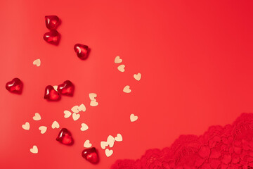 Red Valentine's Day background with beautiful female lacy panties and hearts. Sexy underwear. Free space for text, copy space. Postcard, greeting card design. Love, celebration concept.