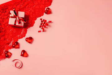 Pink Valentine's Day background with beautiful female lacy panties, hearts and gift box. Sexy...
