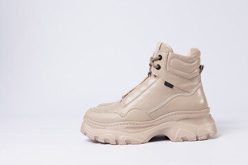 Beautiful shoes on an isolated white studio background. Fashionable beige women's shoe. Elegant stylish footwear.