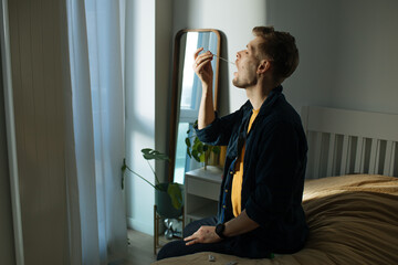 Man swabbing throat with home test for COVID-19. Coronavirus nasal swab test for infection. Rapid...
