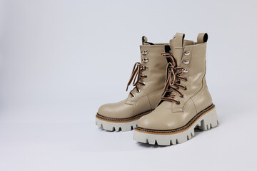 Beautiful beige shoes with genuine leather on an isolated white studio background. Fashionable classic women's boots. Stylish elegant leather shoes.