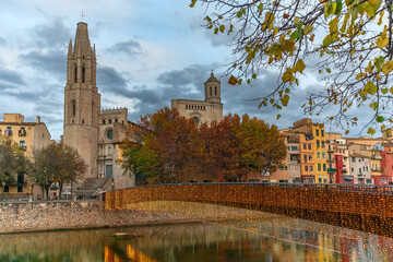 Autumn evening landscape of Girona with Sant Feliu Pedestrian Bridge over Onyar River on the...
