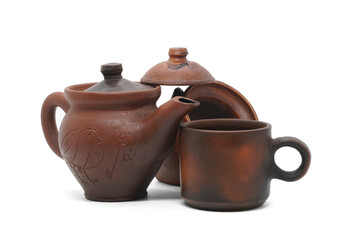 Pottery set. Clay teapot, clay cup, and earthen sugar bowl with the lid removed. Isolated on white background.
