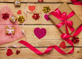 Gift boxes with satin ribbons on a wooden background. The concept of Valentine's Day, Mother's Day and Birthday.