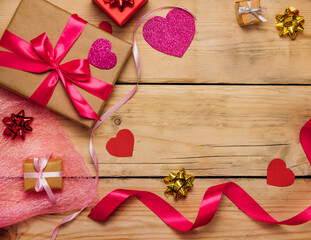 Gift boxes with satin ribbons on a wooden background. The concept of Valentine's Day, Mother's Day and Birthday.