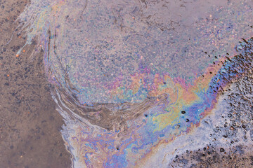 Abstract background from motor oil, gas or petrol spilled on asphalt