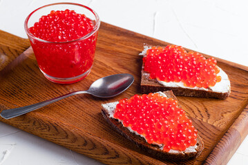 red caviar, fish caviar, on a concrete background