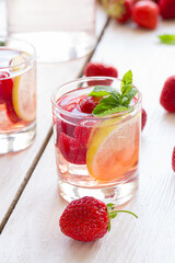 fresh lemonade with strawberries , lemon and mint