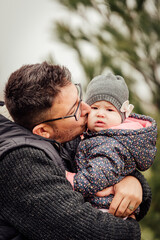 Fototapeta premium Father playing with his daughter outside in the park