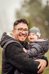 Father playing with his daughter outside in the park