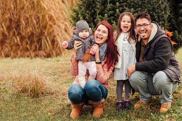 Family with two daughters having fun in the park