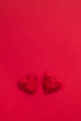 Two red heart on a red background. Valentines day greeting card. Copy space.