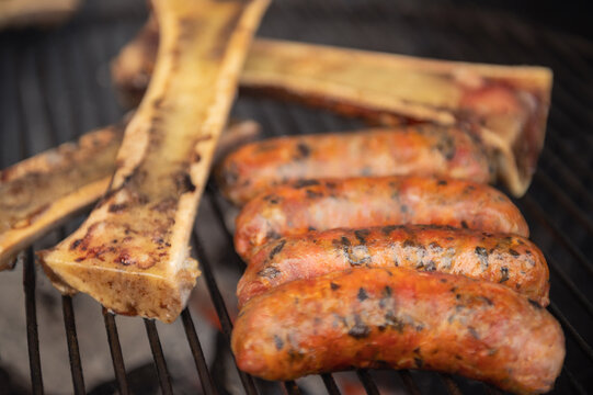 Grilled with rib of beef, chistorra and sausages. Golden sausages ready for the celebration of the picnic. Charcoal grill concept. Amatlan, Mexico