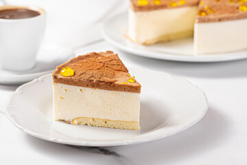 A piece of bird's milk cake on a white plate