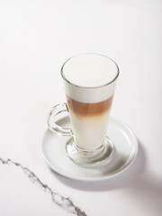 Latte in a glass mug on a white background