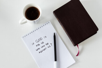 If God is For us who can be against us handwritten message on notepad with marker, closed Holy...