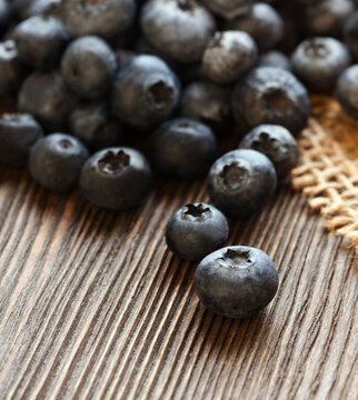 Blueberries heap ripe sweet berries on wooden table, top view