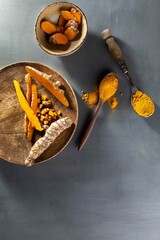 Healthy spices curcuma poweder and roots on grey background .Copy space